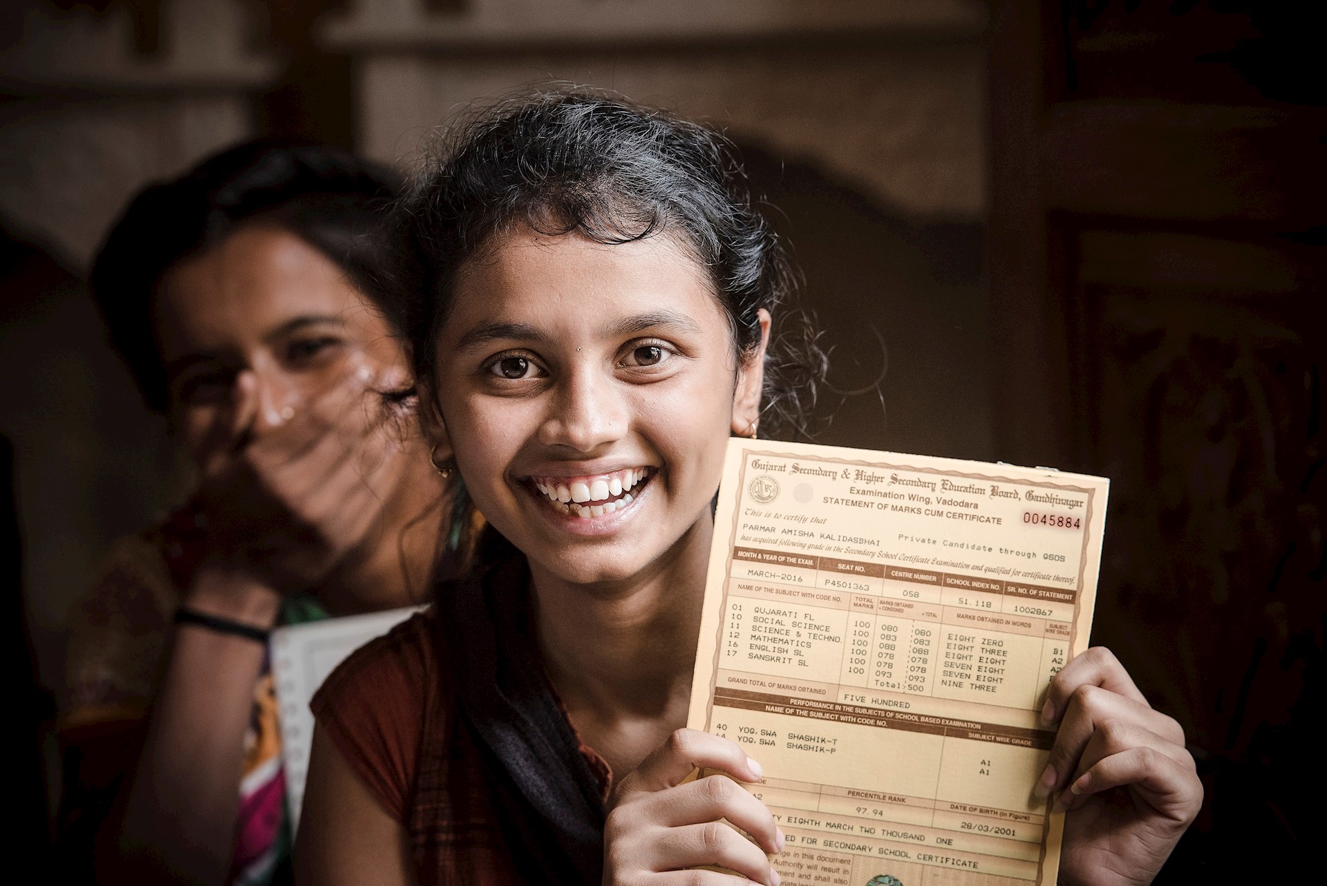 Girl with certificate, India 