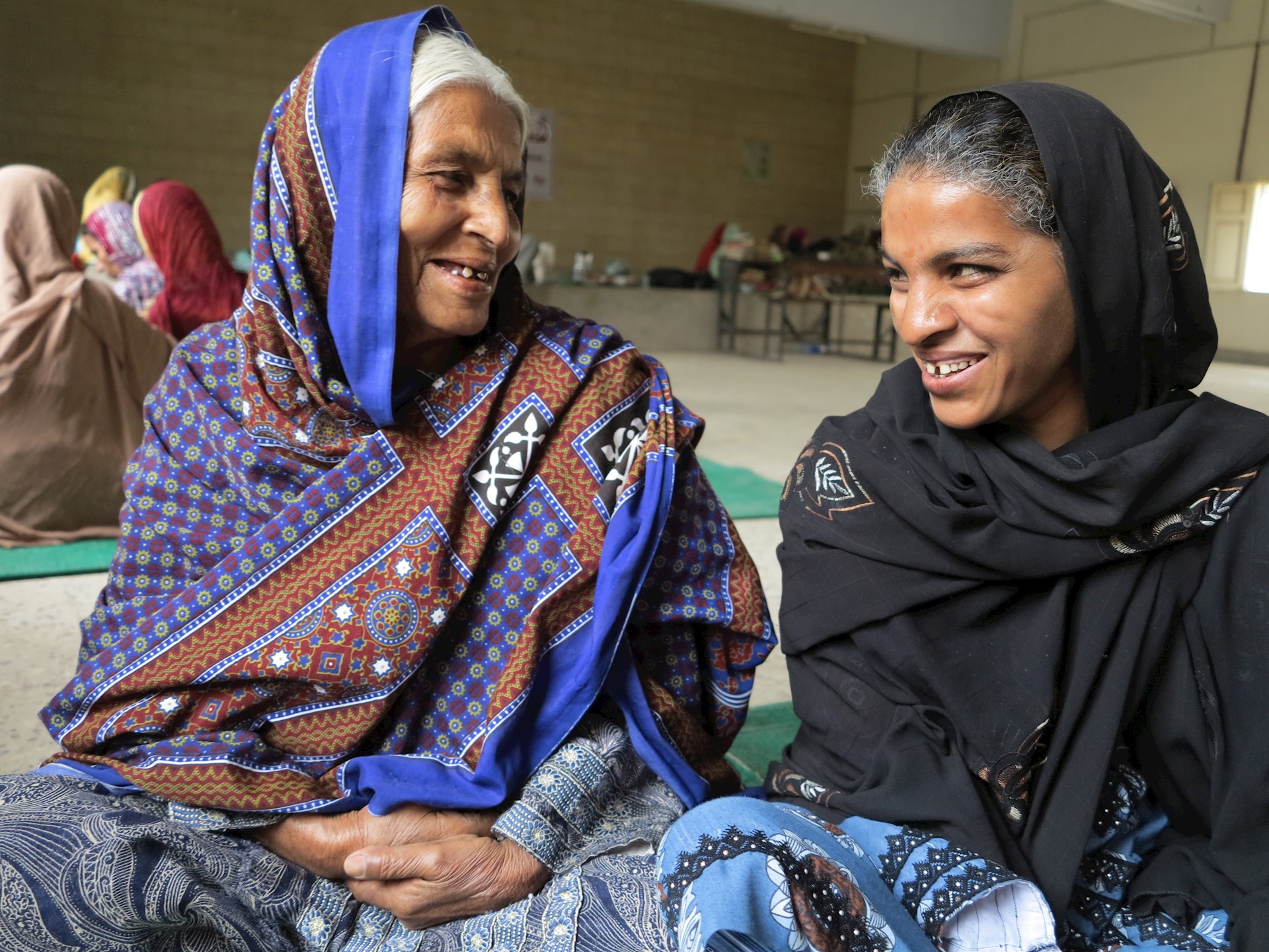 Two women laughing together, Pakistan