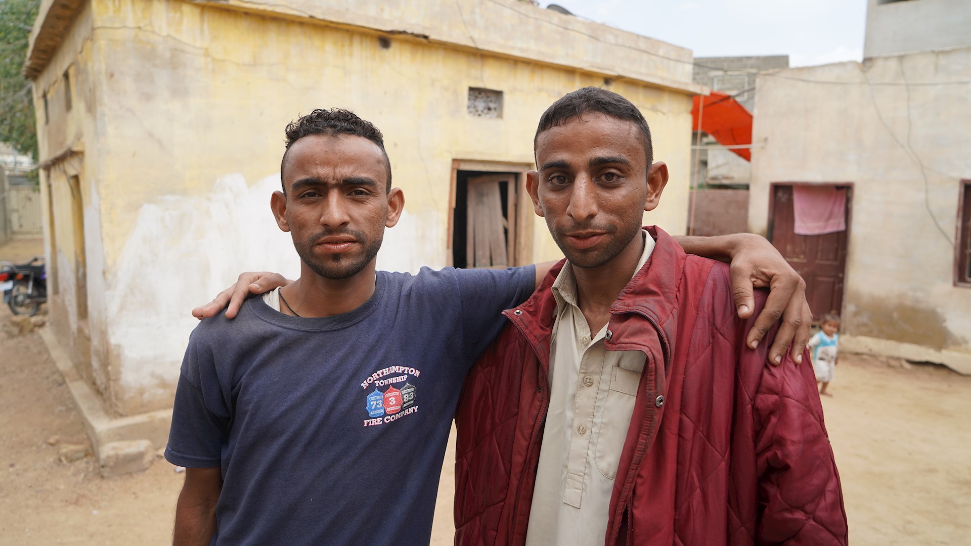 Two brothers arm in arm, Pakistan 