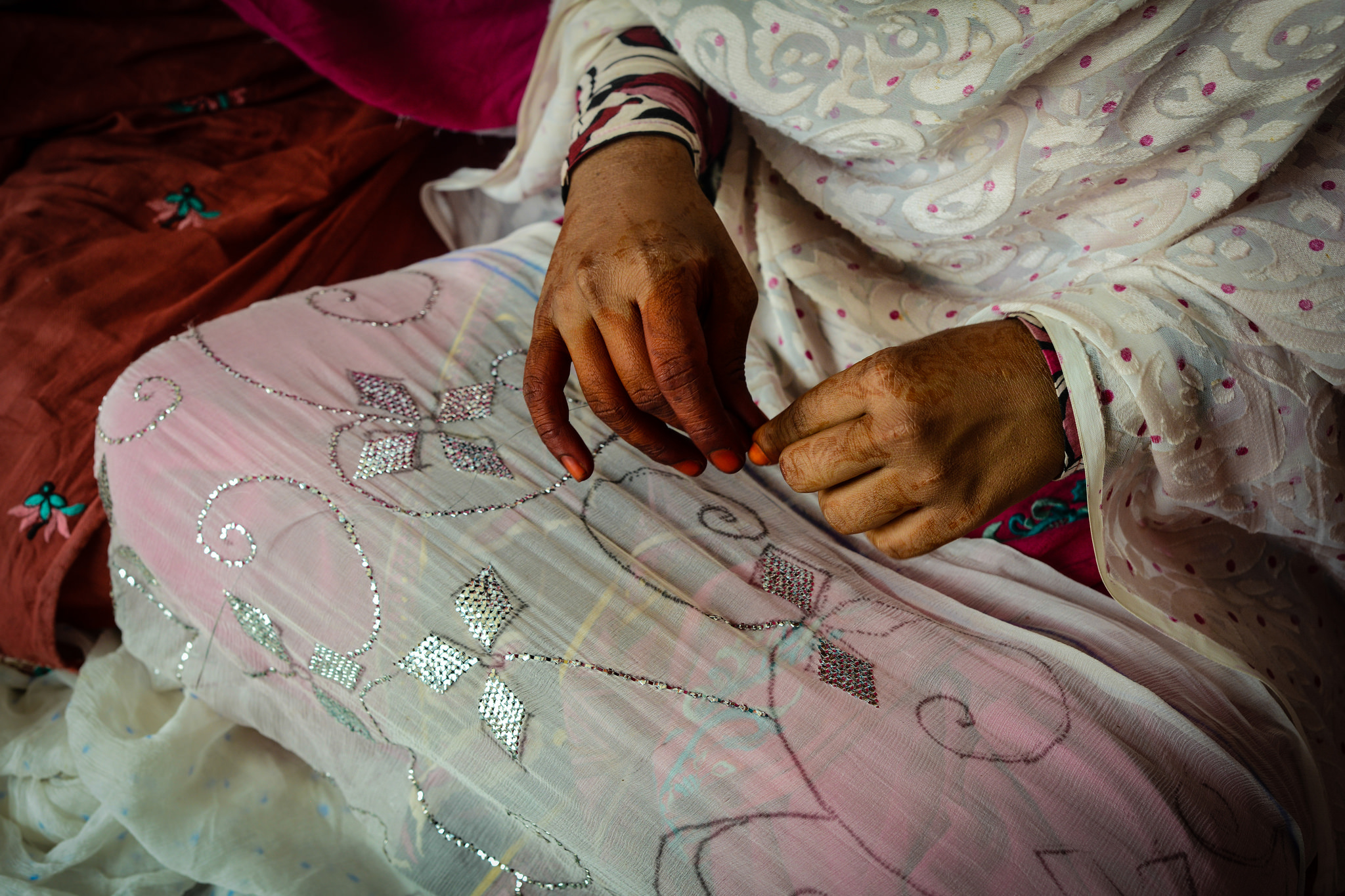 a woman's hands sewing 