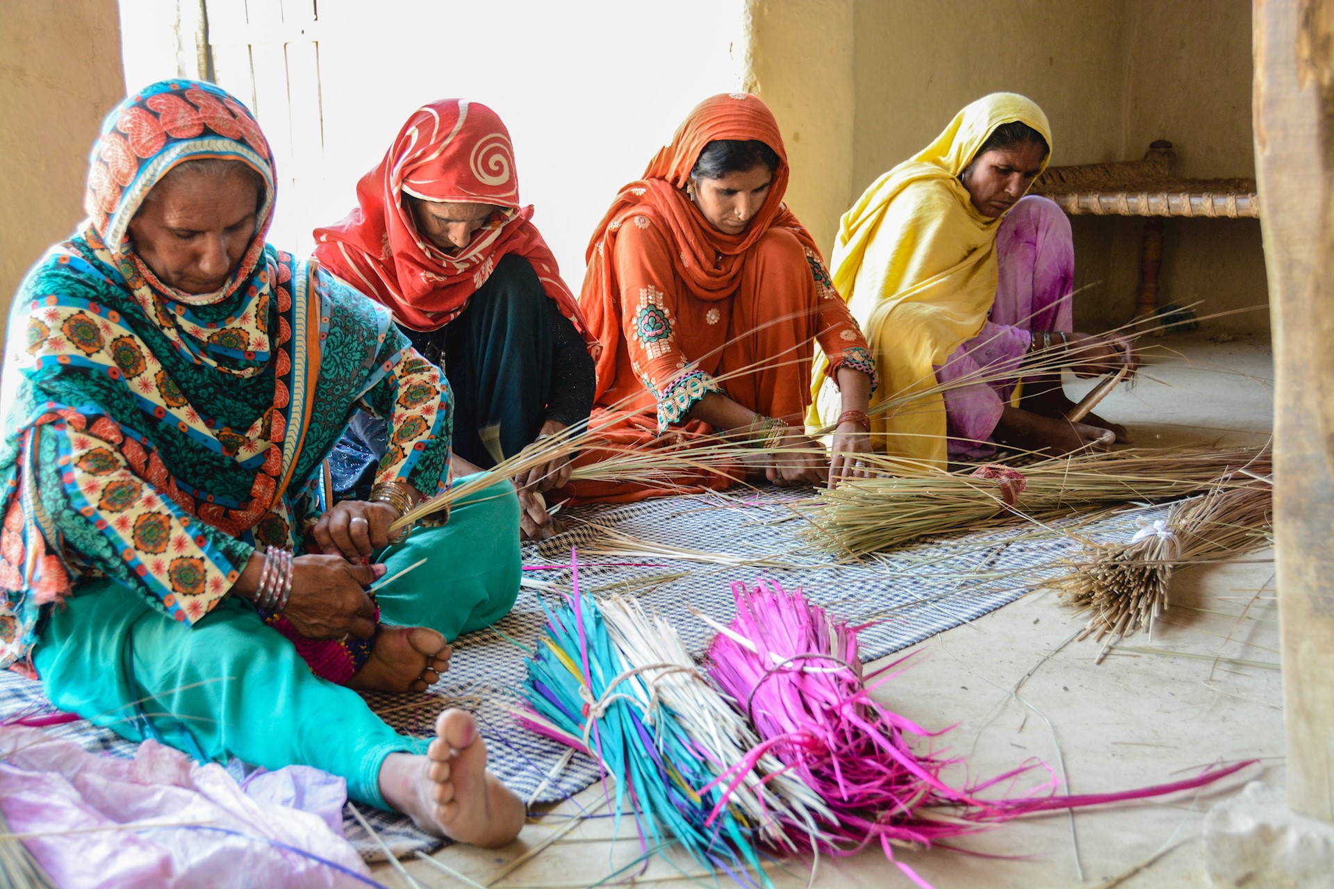 4 women weaving 