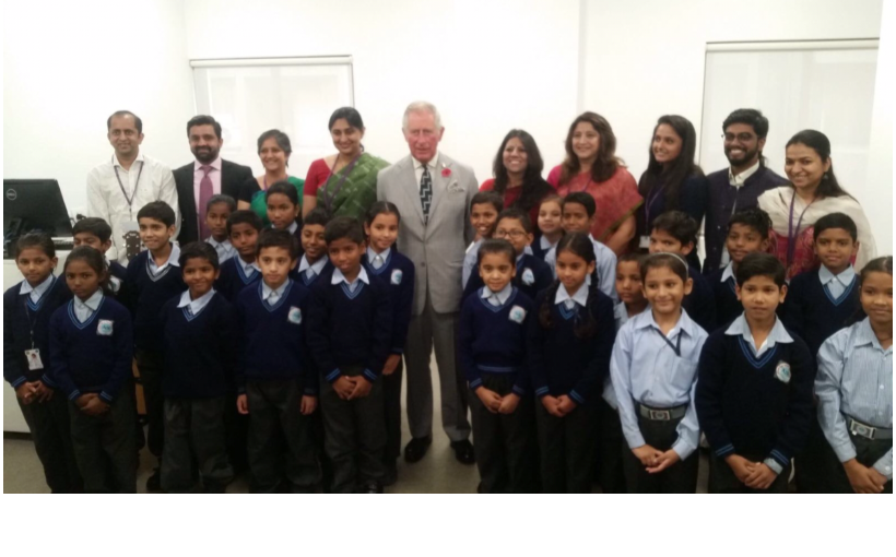 HRH The Prince of Wales posing with school children in India 