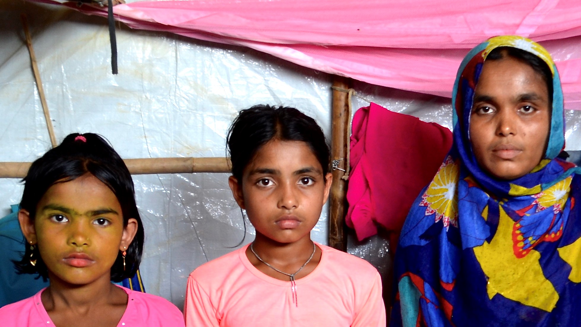 woman standing with her two children 