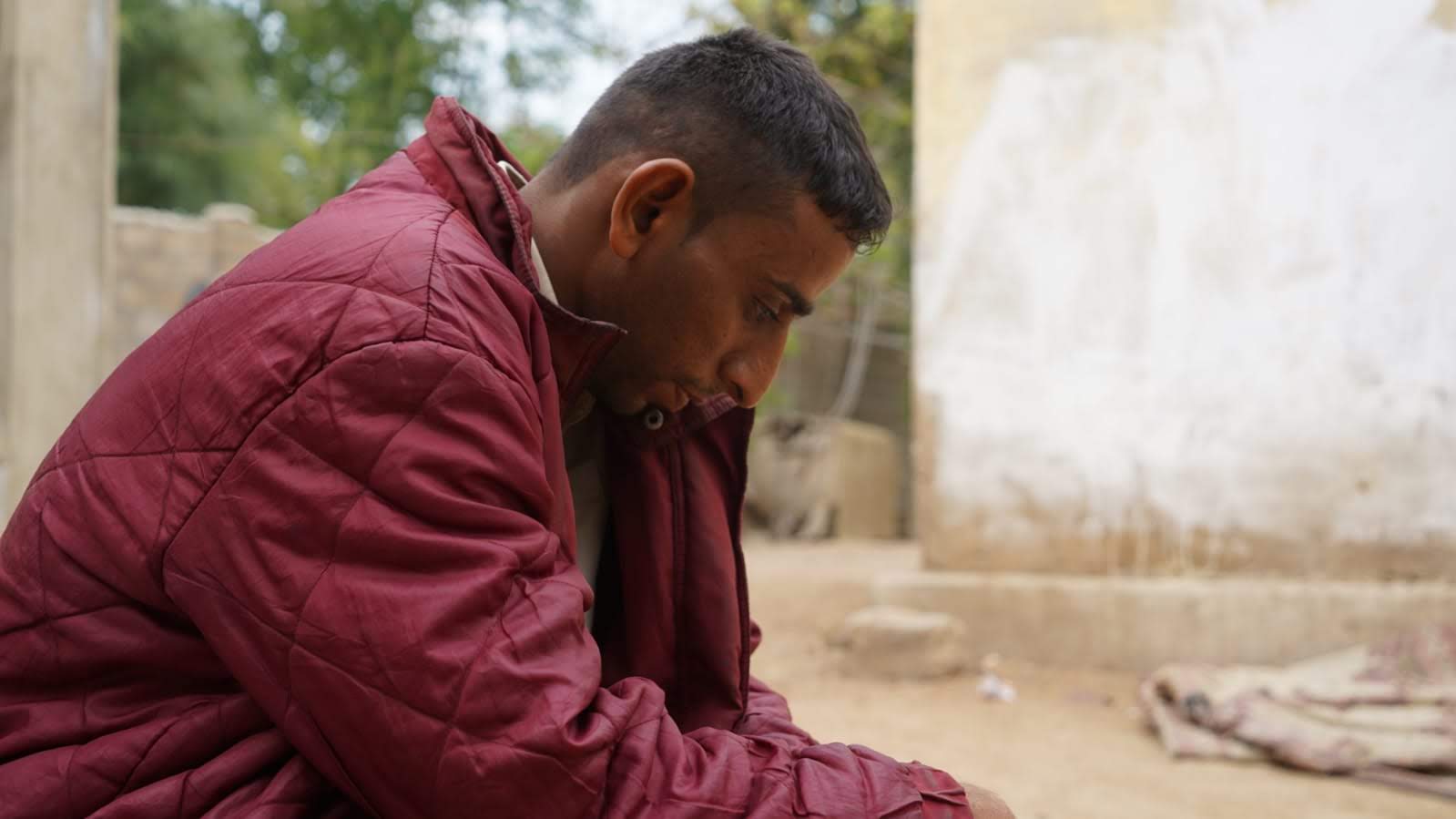 side profile of young man leaning against his hand 