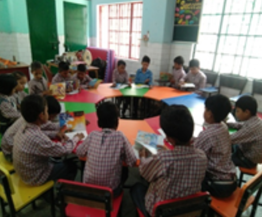 classroom of children on a round table 